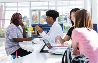 Group of four students studying in the Sanford/Lake Mary campus Student Center building